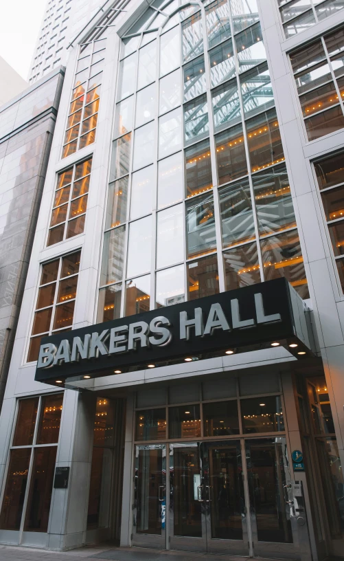 a street corner with a bankers hall sign on the front of it