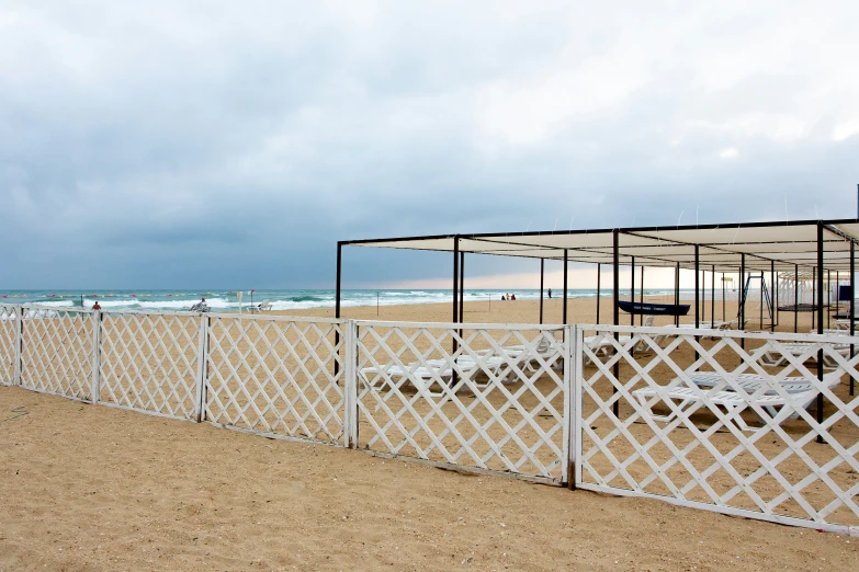 an umbrella covered beach next to the ocean