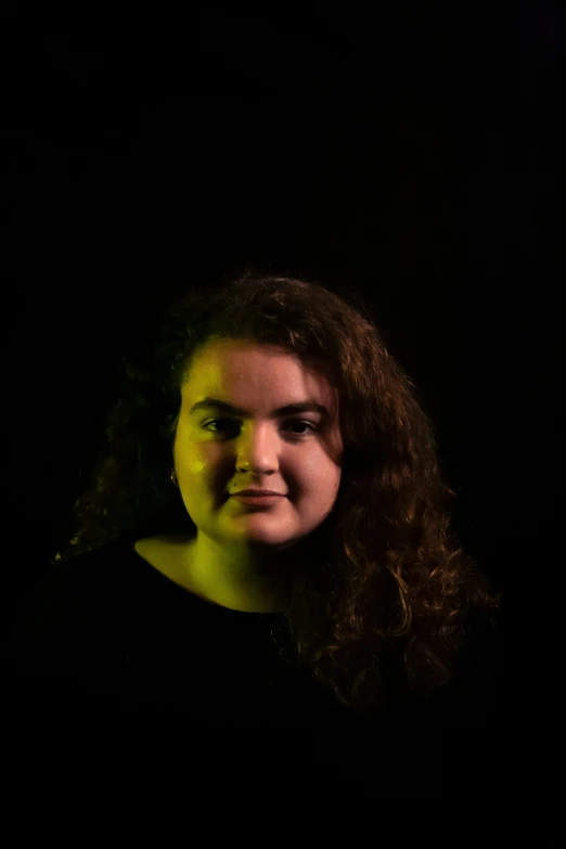 a beautiful woman posing with dark background