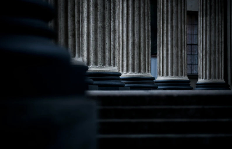 a dimly lit room with a couple of columns