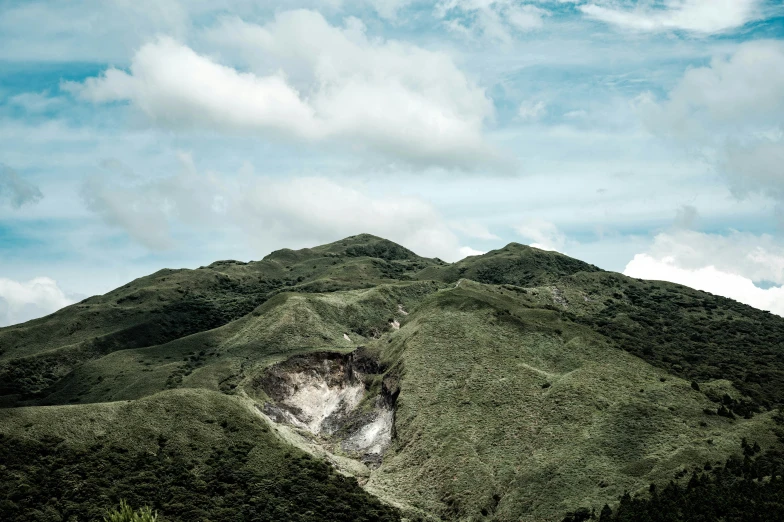 an almost empty hillside under the sky