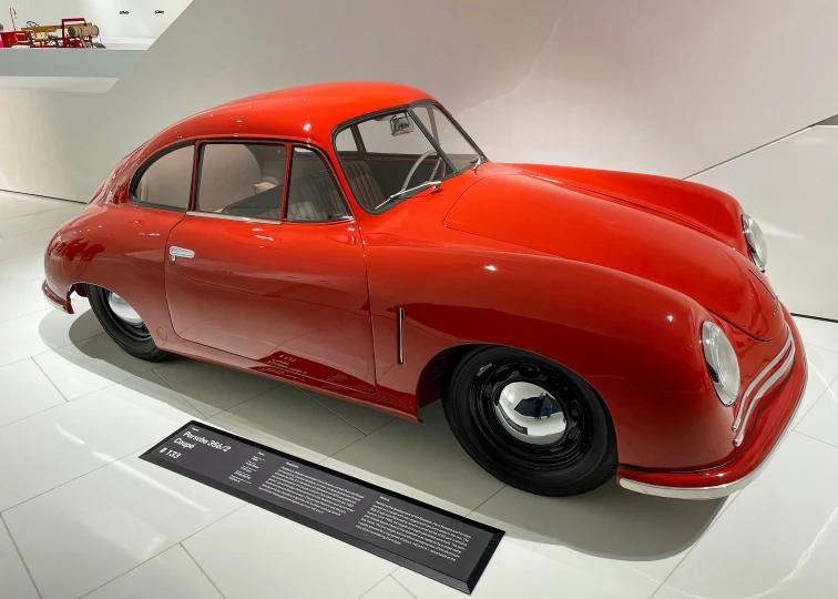 the old fashion car in the museum is painted red