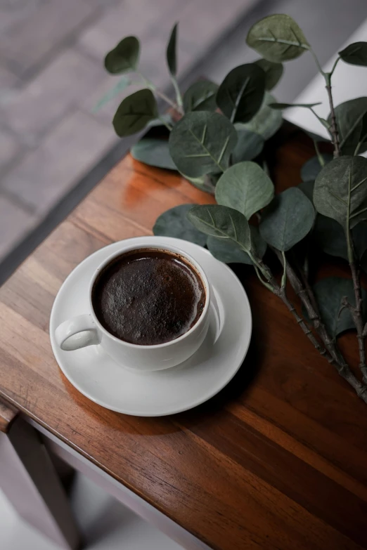 a close up of a plate on a table with a cup of coffee