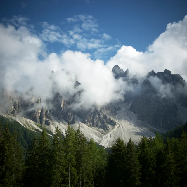 the view of a mountain in the clouds