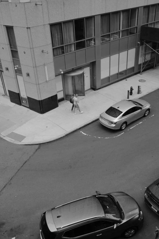 cars are parked at a intersection in the middle of town