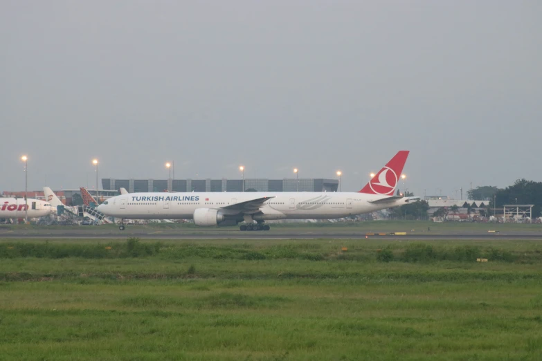 an airplane is on the runway in the grass