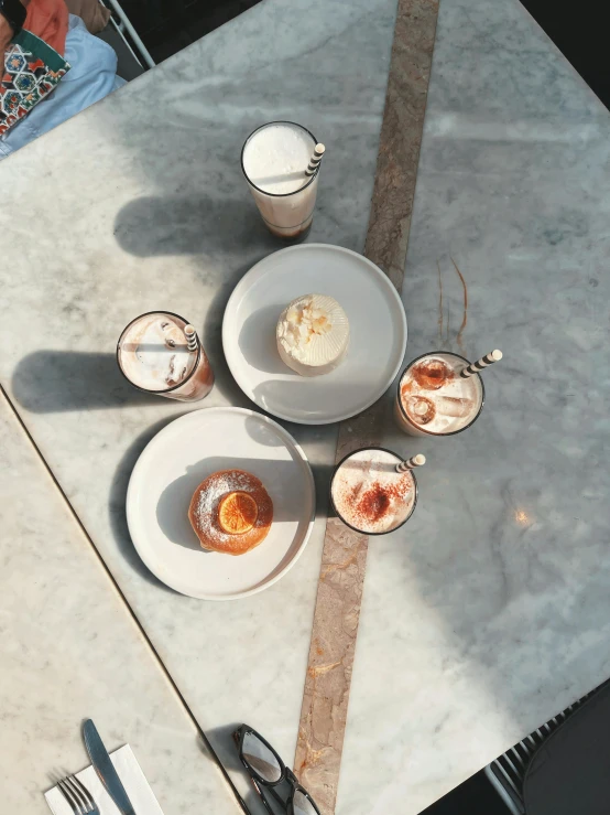 a table topped with plates and desserts on top of it