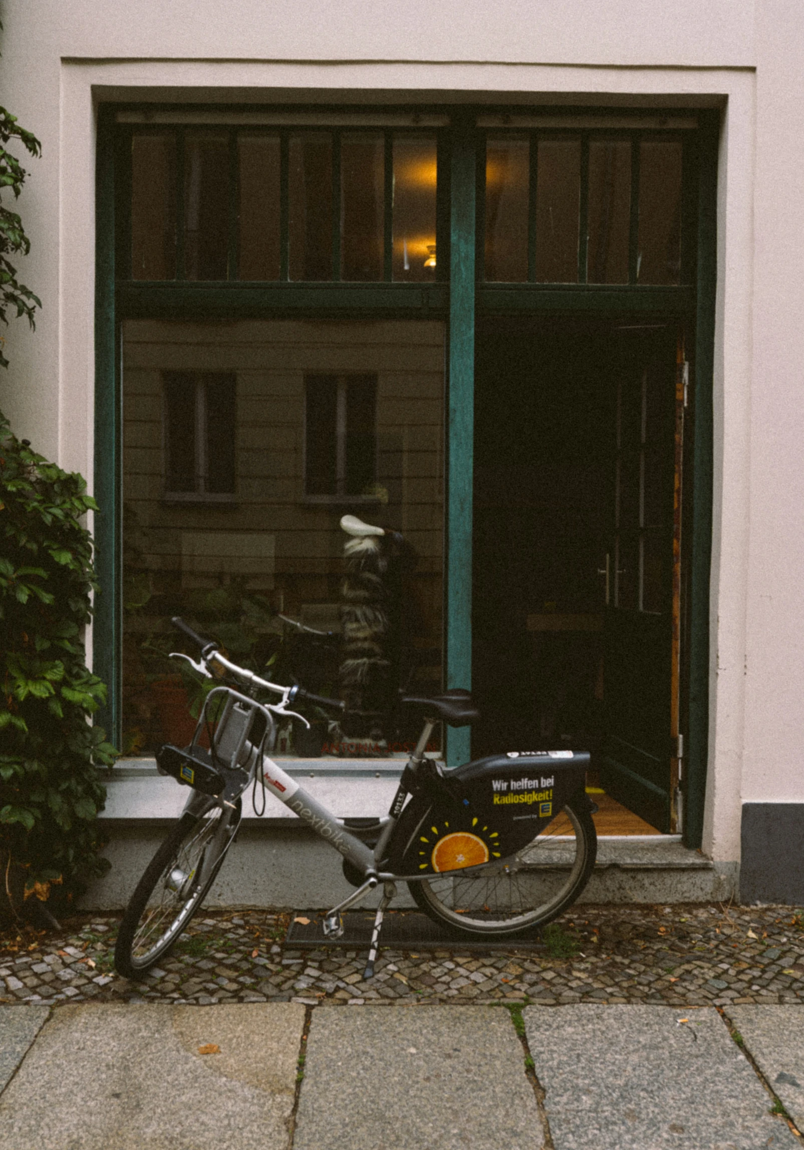 a bicycle parked in front of an open window