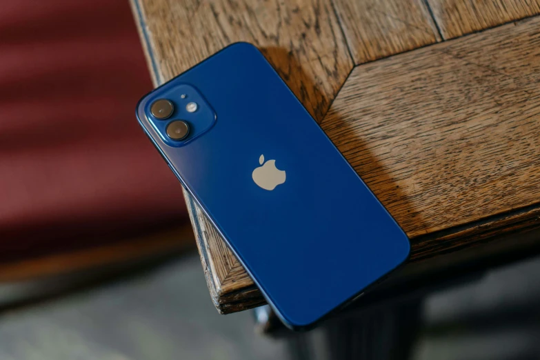 the apple logo is on the back of a blue iphone