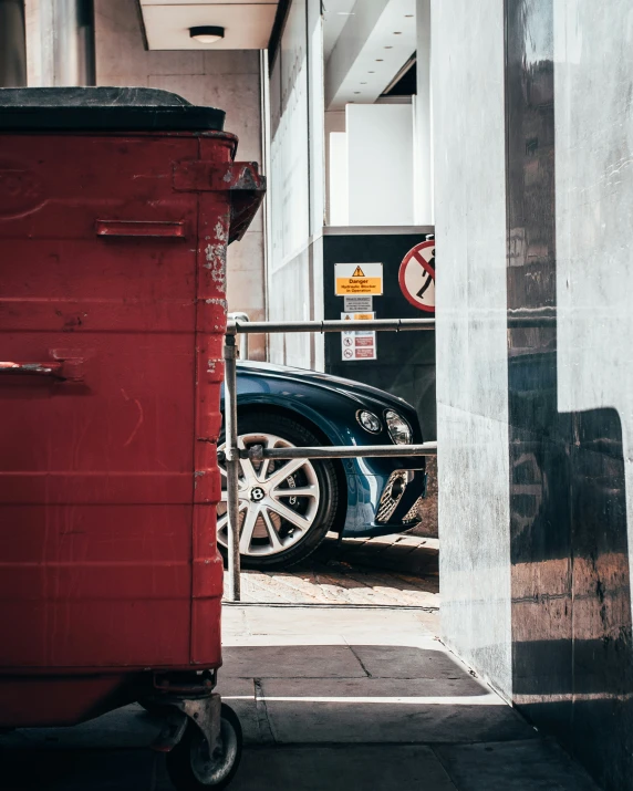 a car is parked in the street behind a hand rail