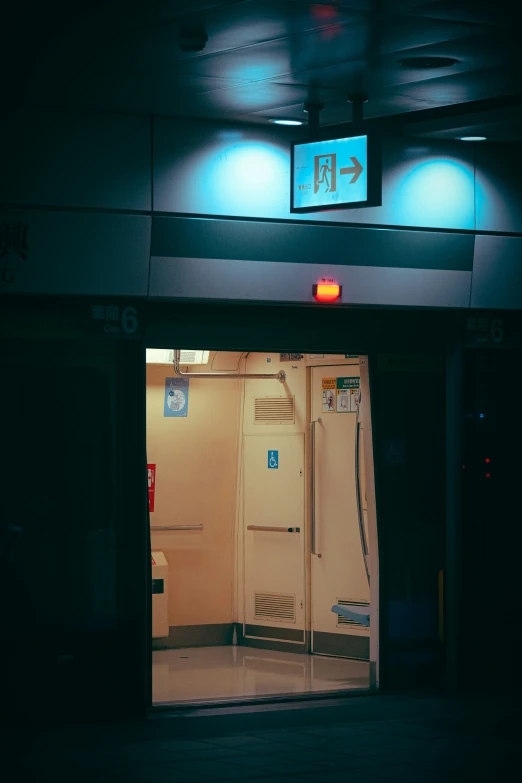 an elevator with doors that are open and a red light