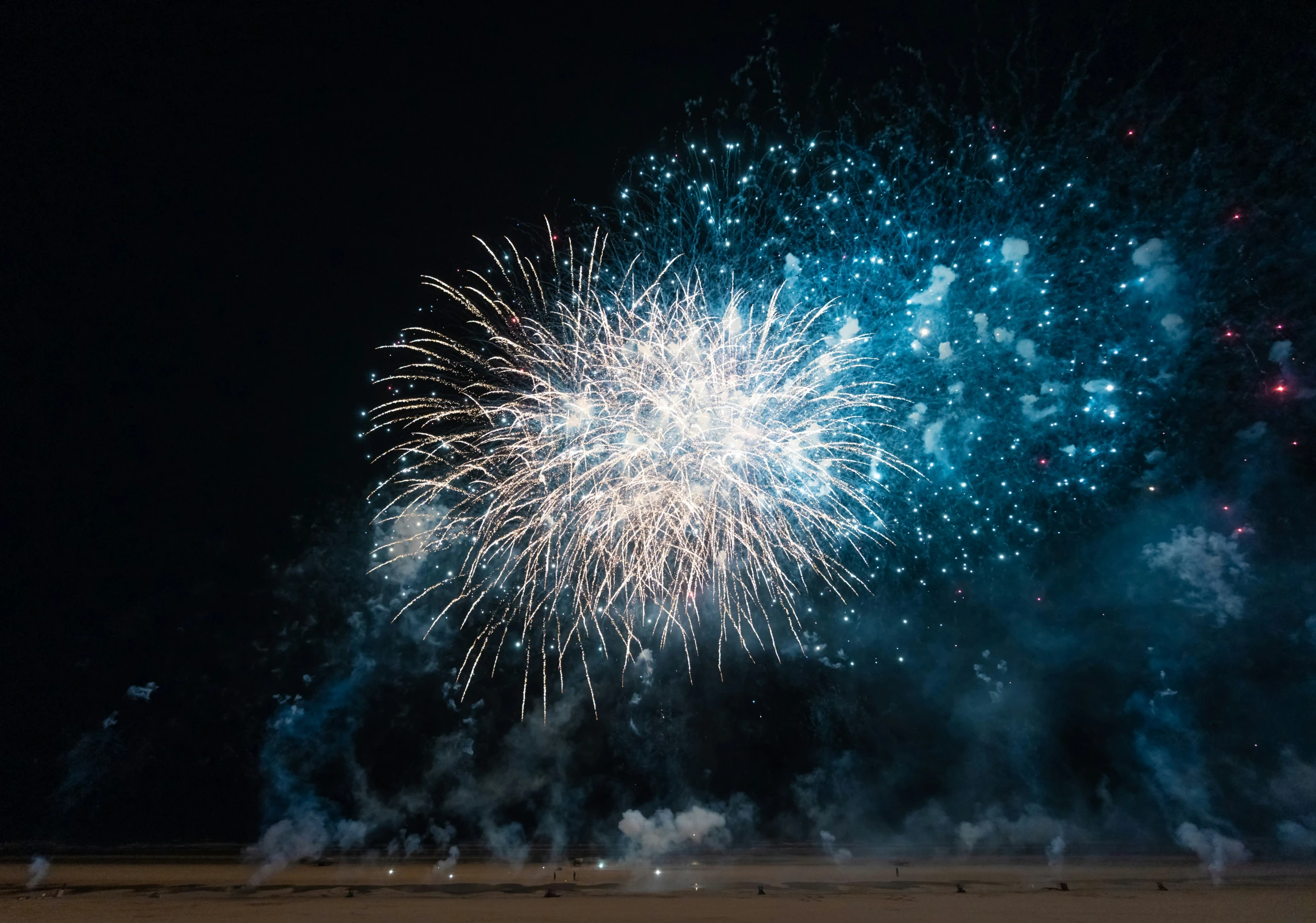 fireworks exploding and illuminating in the night sky