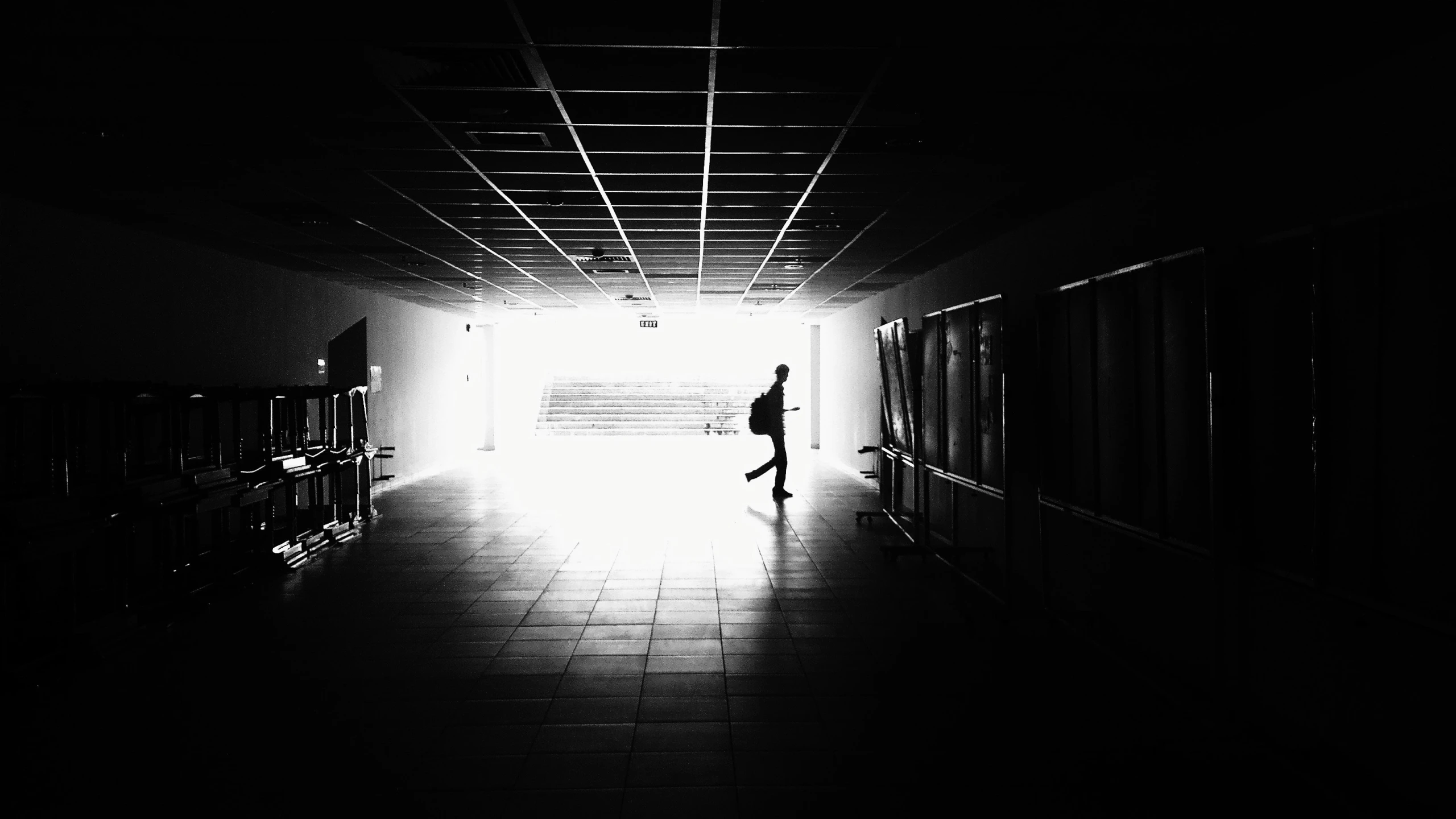 a dark hallway with the light at the end