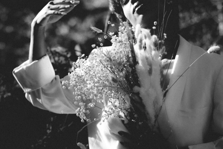 the woman is holding the flowers to take pictures