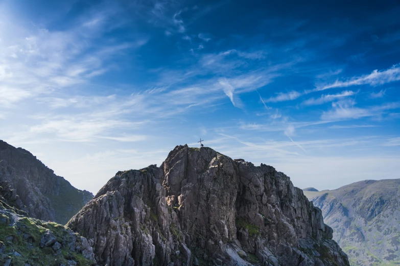 people standing at the top of a very tall mountain