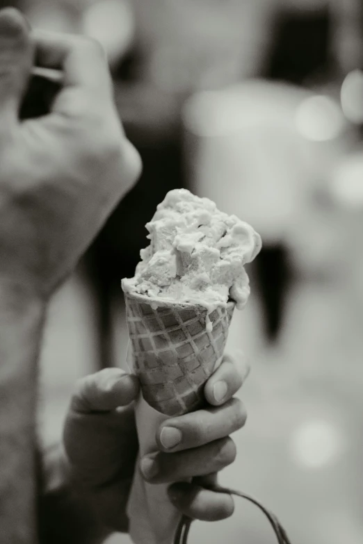 woman holding up a scoop of ice cream in front of her
