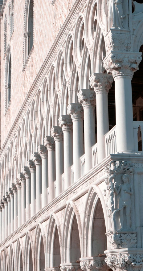 a tall building with arches and pillars on each side