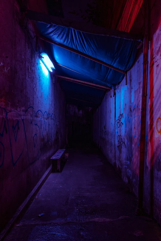 a tunnel with no people is lit by the colorful light