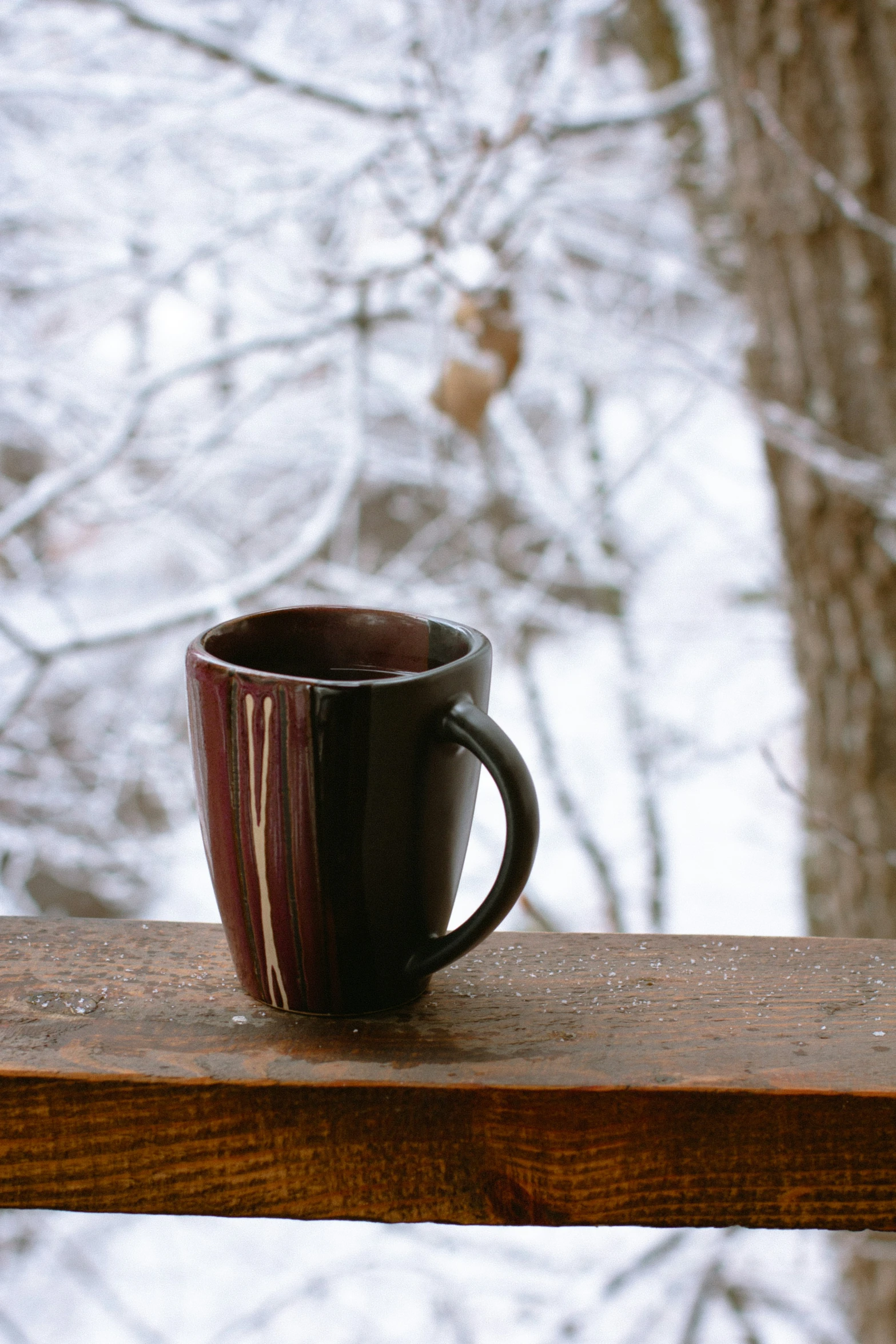 there is a coffee mug that is sitting on the railing