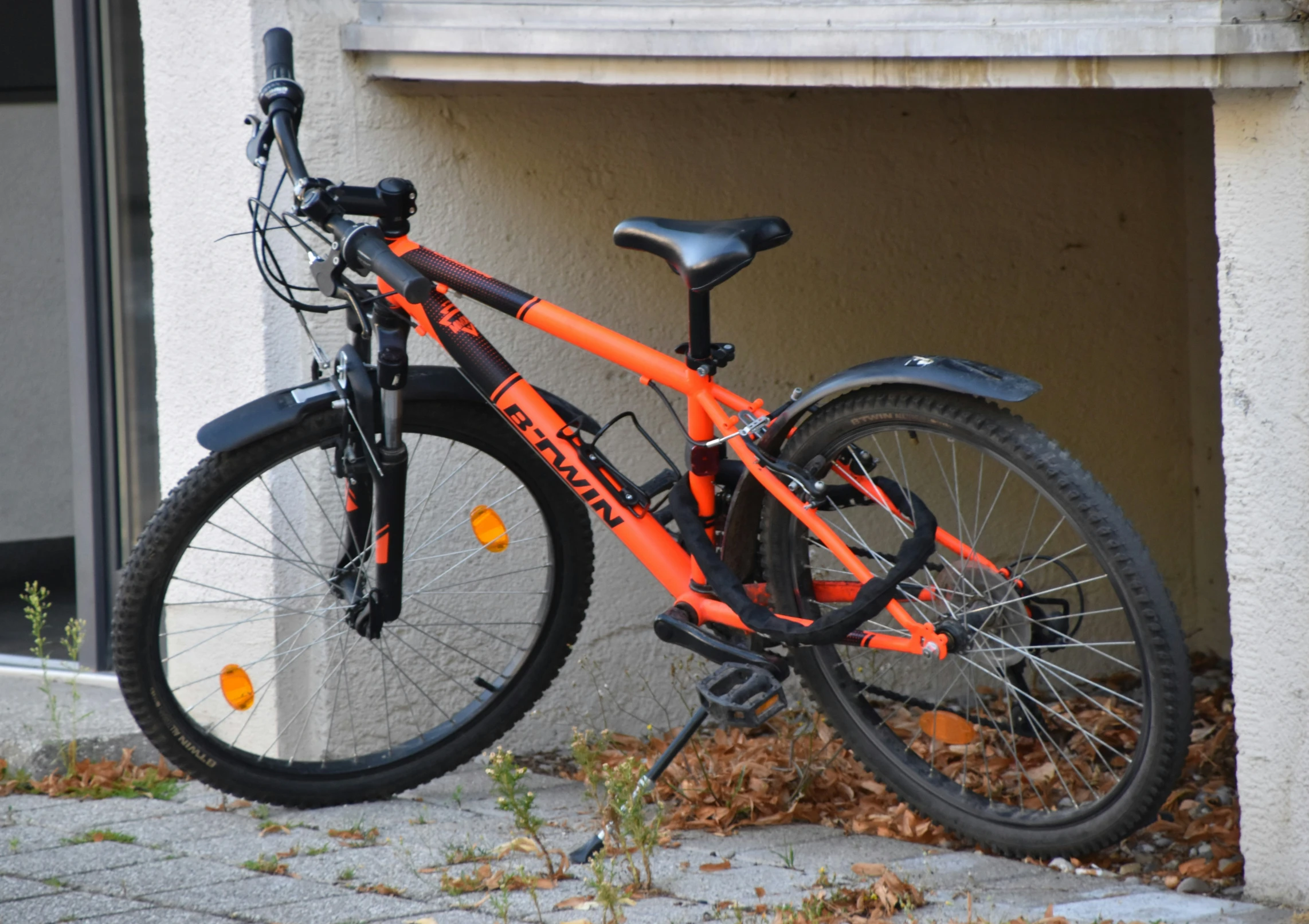 a bike is parked next to a building