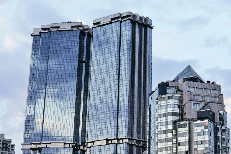 three skyscrs stand in a downtown setting