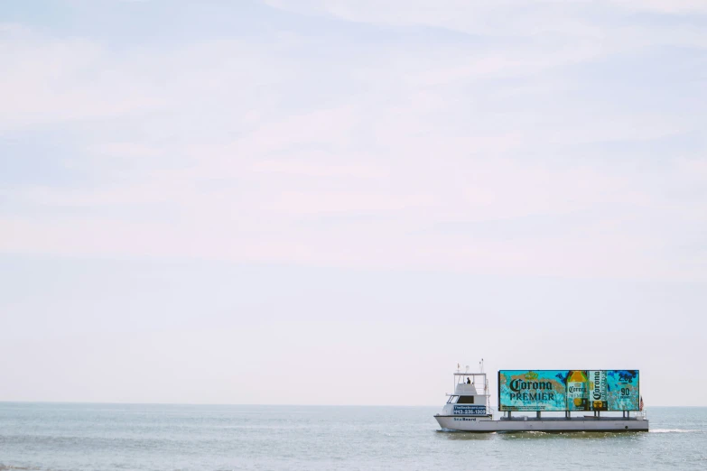 a boat traveling across the ocean on an overcast day