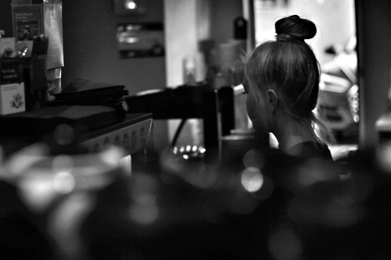 a person standing in front of a counter with wine glasses on it