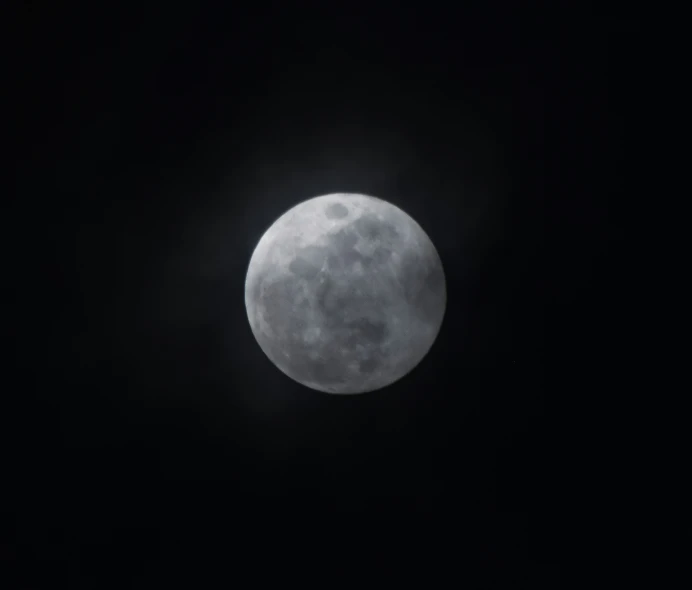 a close - up view of a large, dark moon seen from a low distance