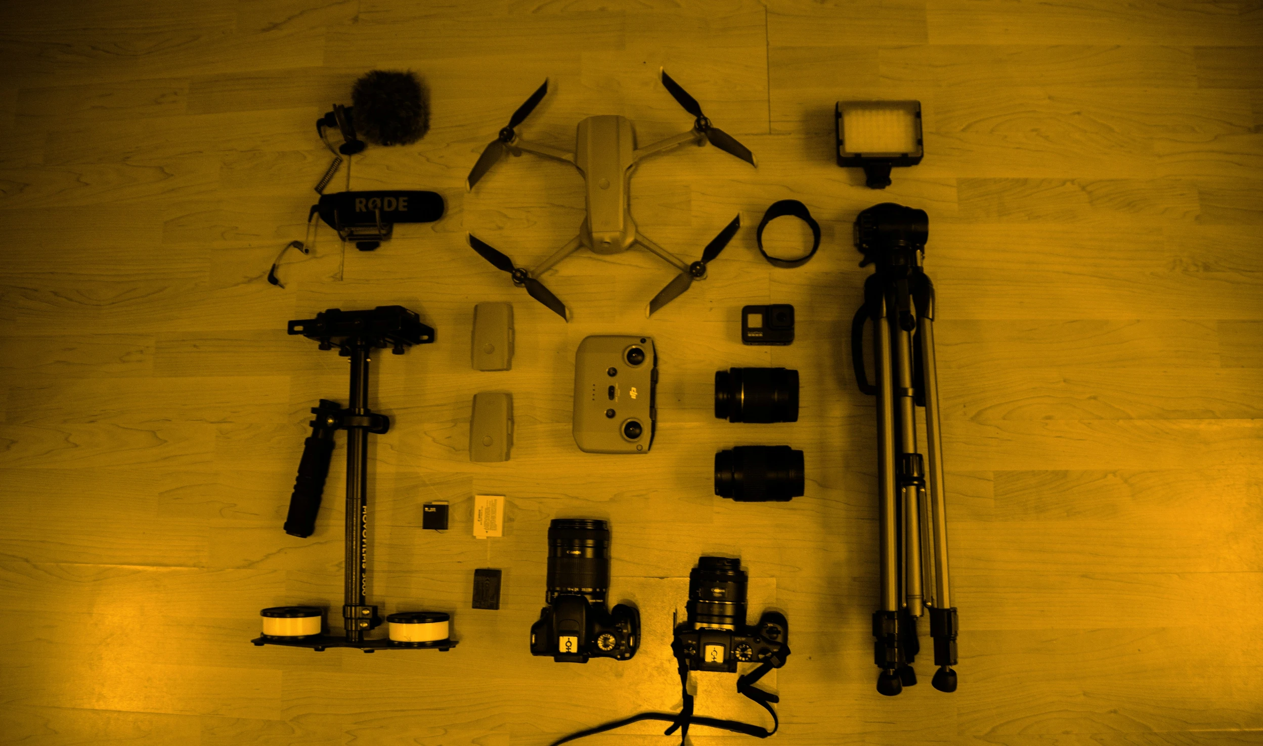 various devices laid out on the floor, including remotes