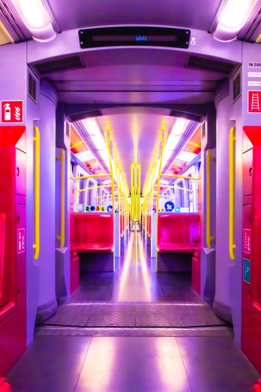 a view of a corridor in an industrial facility with several red seats and yellow doors