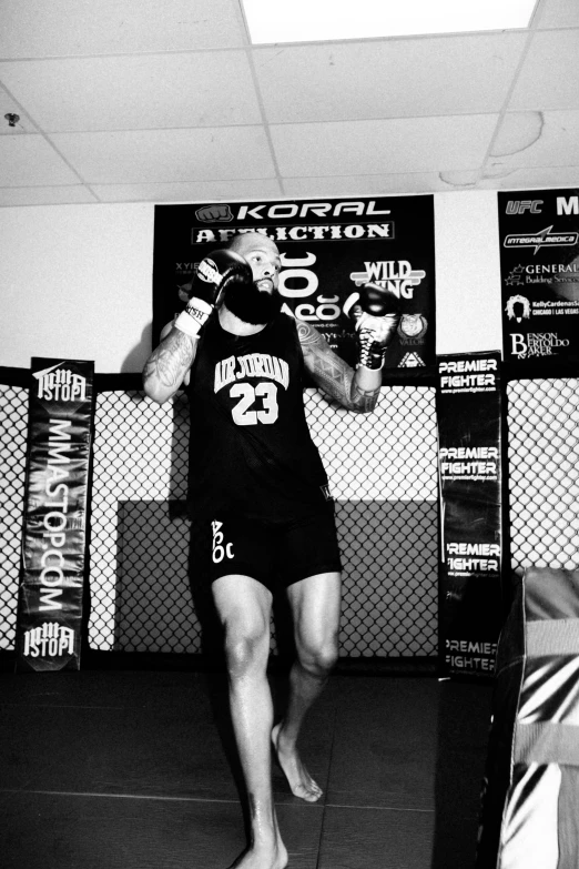 a person in a gym boxing ring with their hands up