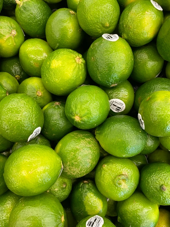 some bright green citrus fruit is in an arrangement