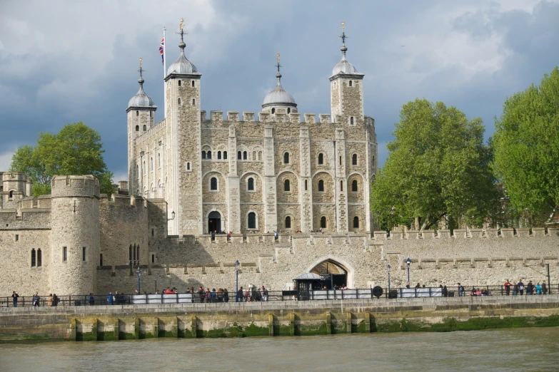 a castle like structure stands beside the water