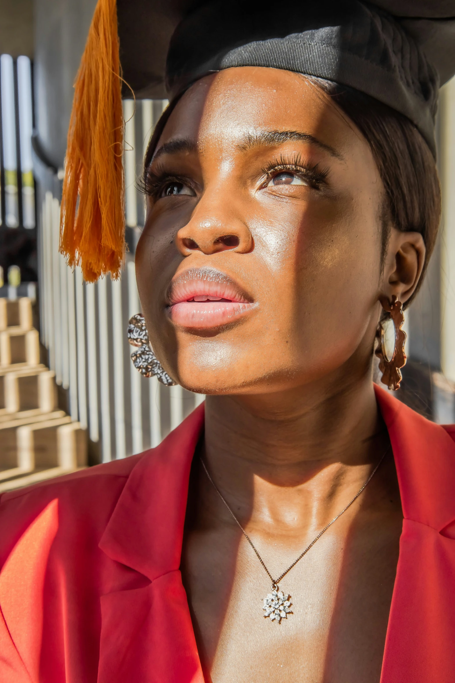 a woman wearing an orange jacket and a cap