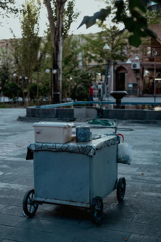 three trash cans are in the yard next to each other