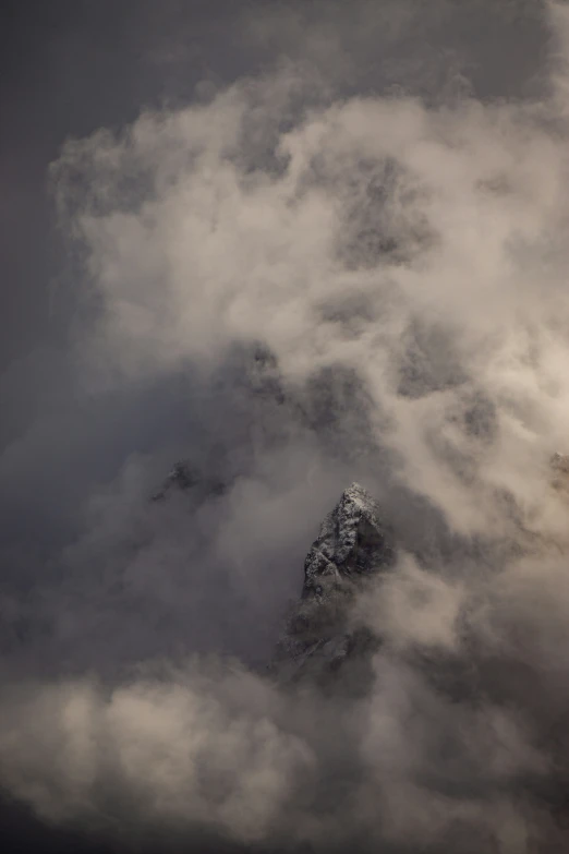 an image of a mountains view through the clouds