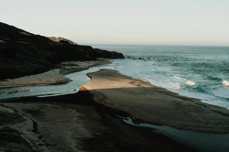 a large body of water near a rocky beach