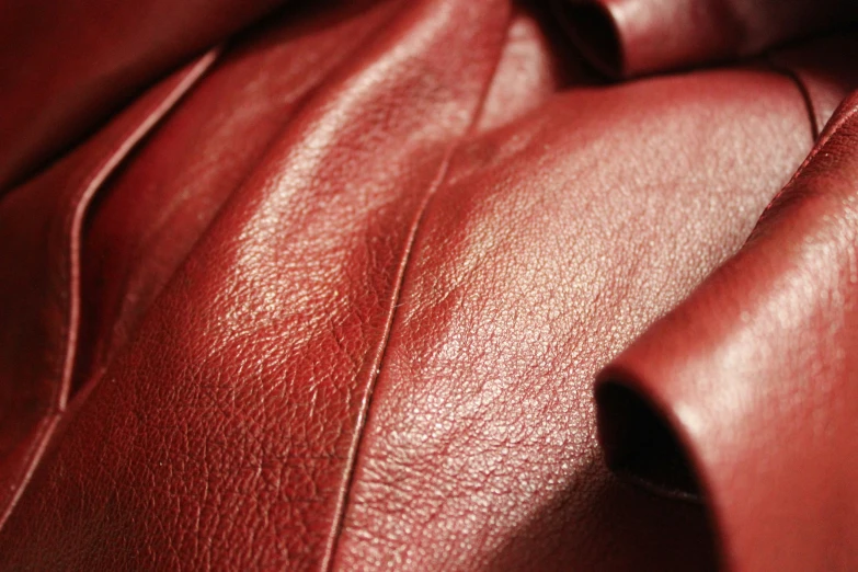 a red leather couch with a knot in the center