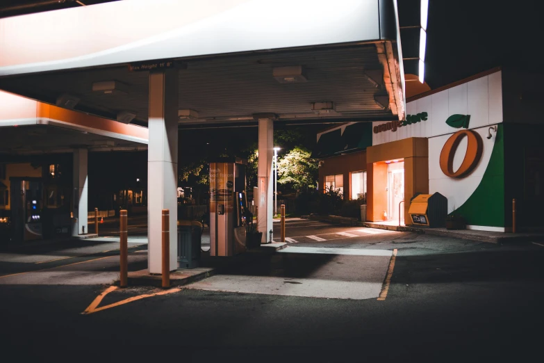 the car is parked next to a gas station