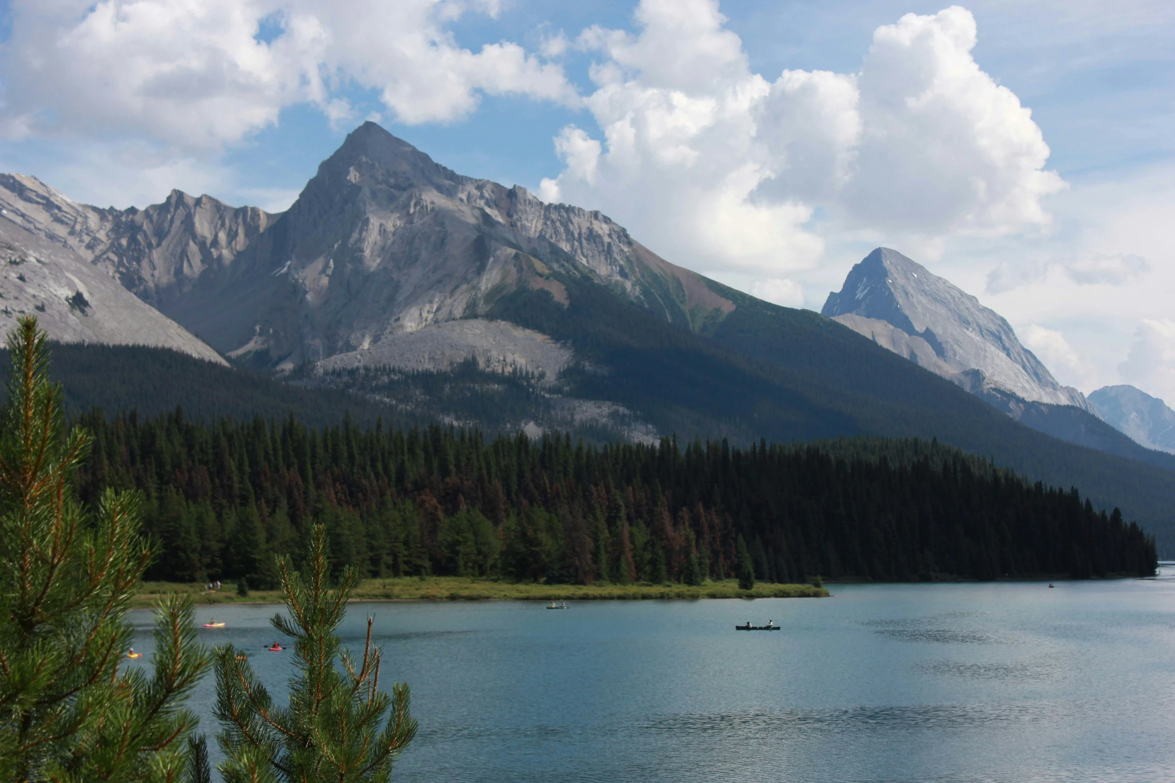 an image of some mountains with people out in the water