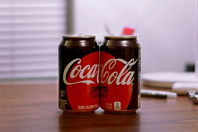 two cans of soda on top of a table