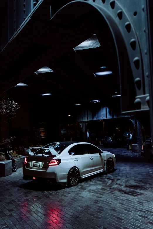 a car parked in front of some buildings at night