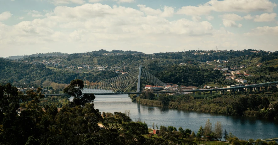 the view of an old bridge from high on a hill