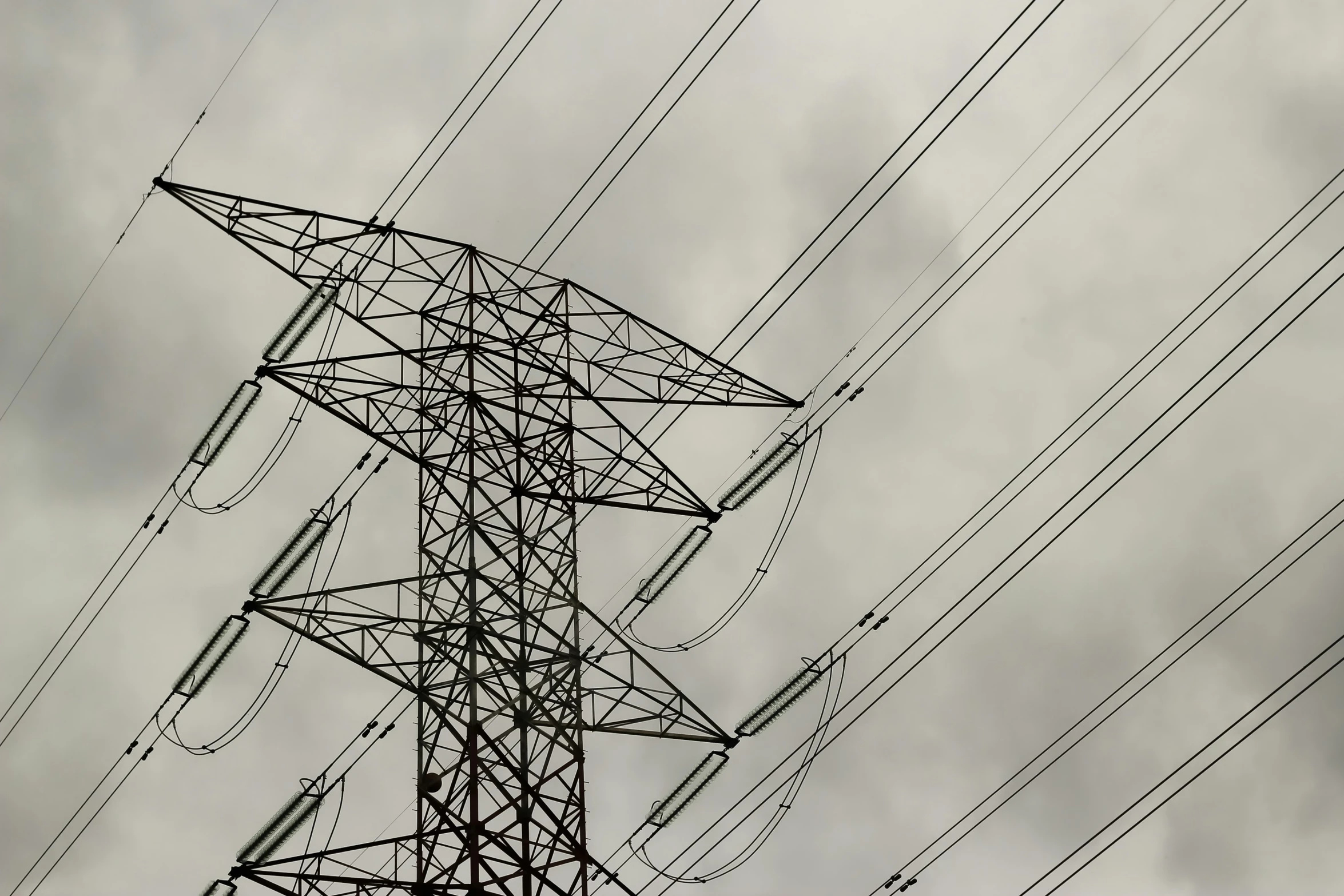 an electric tower in the cloudy sky