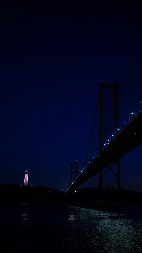 an airplane flying low by the very tall bridge