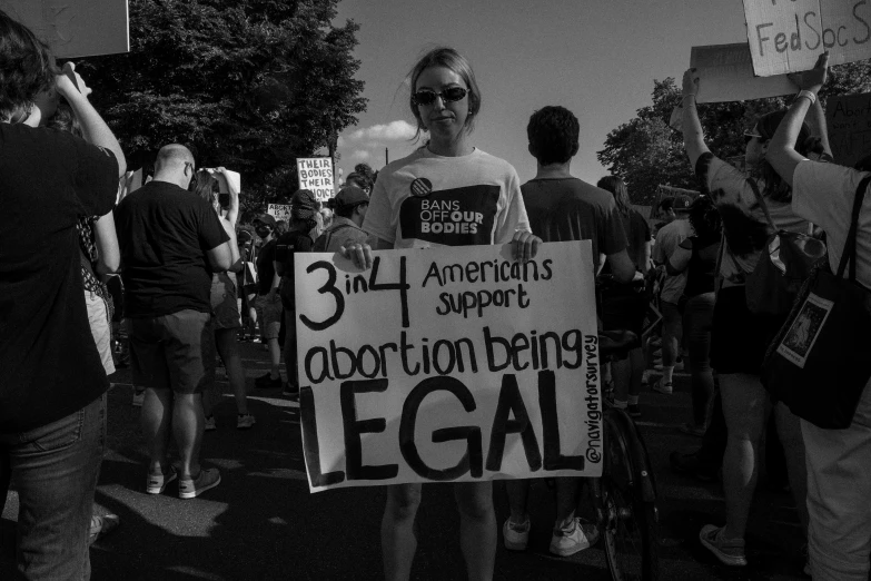 a group of protesters stand in the street