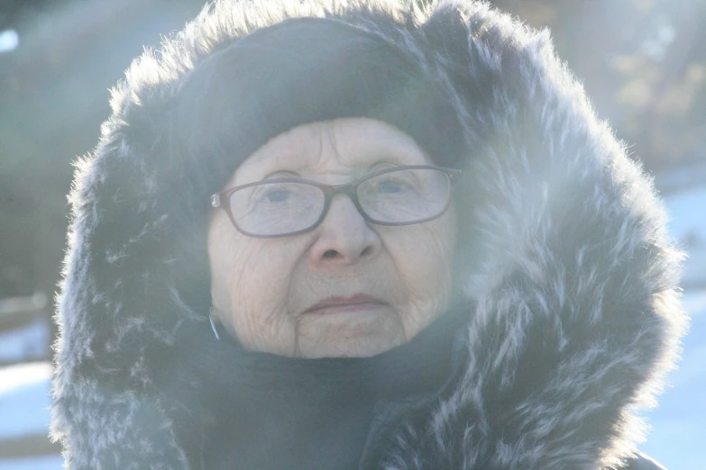 an old woman in a fur collar staring straight ahead
