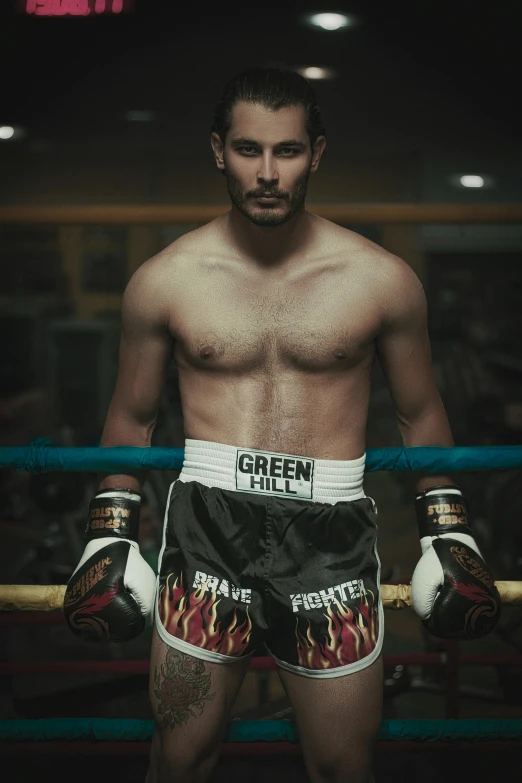 a male in a black boxer shorts and boxing gloves