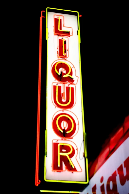 a neon sign sitting on the side of a building