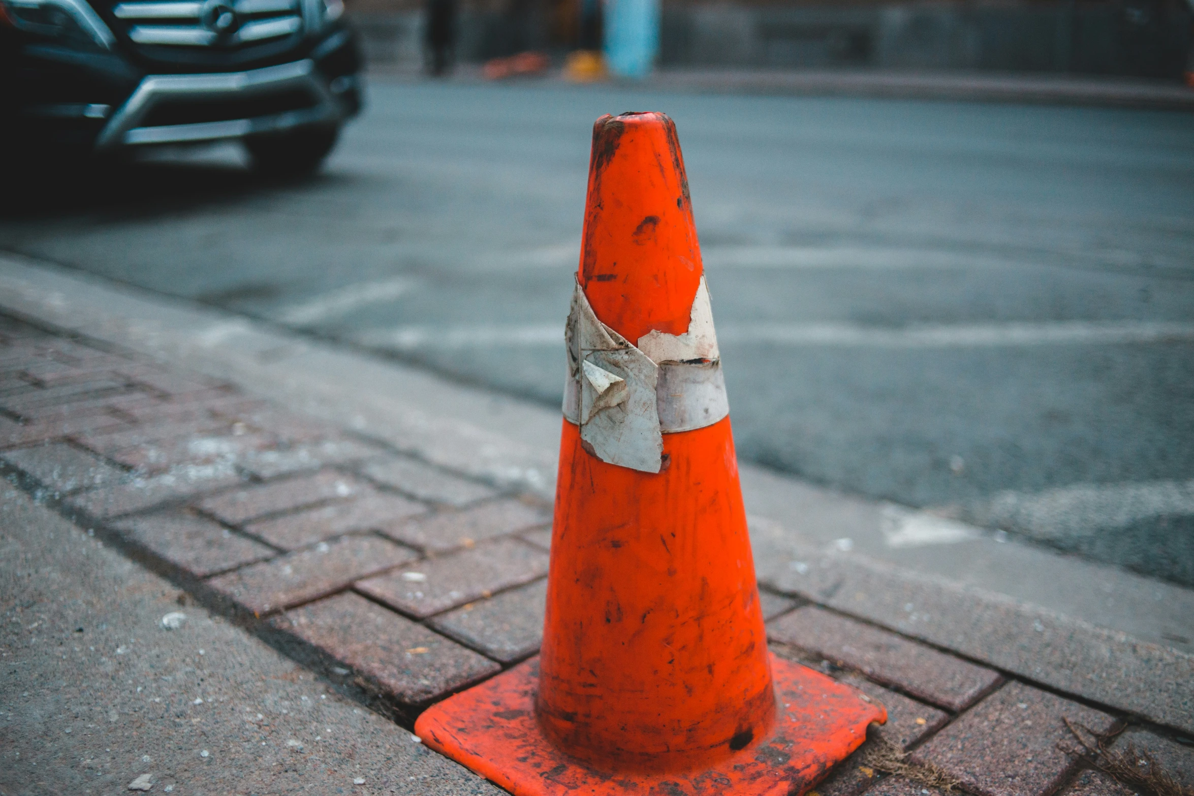 a traffic cone has been placed on the sidewalk